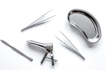 instruments of gynecologist on white background top view