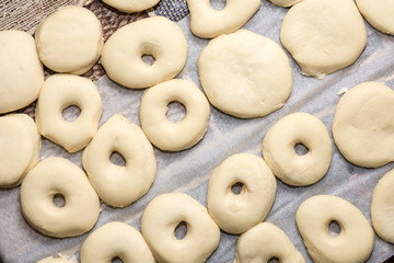 Flat lay above raw donuts dough ready for frying