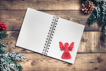 Blank paper notebook on brown wooden table background. Top view