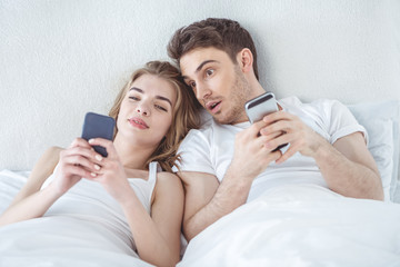 couple using smartphones