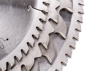 tips of the teeth of a new ripping saw blade on a white