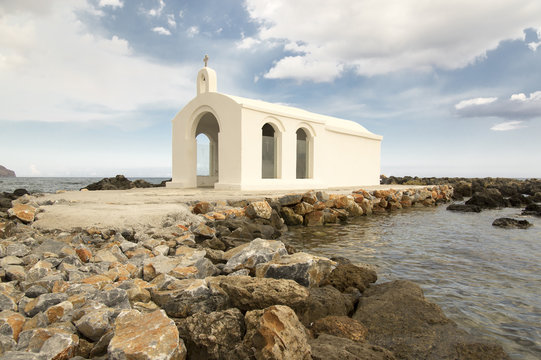 Saint Nicholas small church, amazing white chapel abandoned in the sea on the stones and rocks