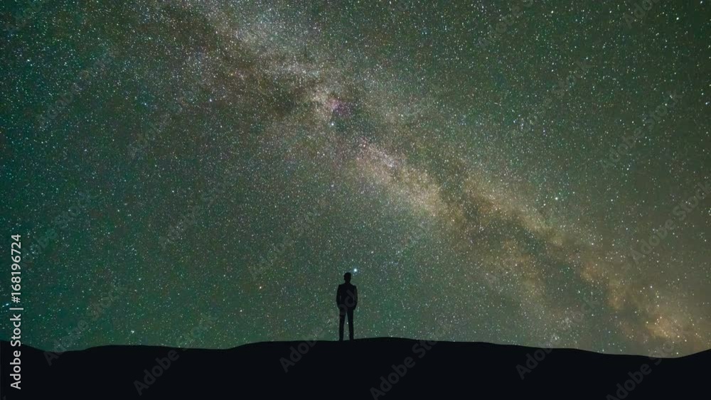Sticker the man stand on a background of a milky way with asteroids skyfall. time lapse