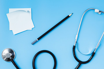 Stethoscope on a blue table, concept of medicine