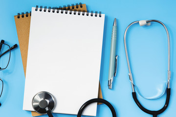 Stethoscope on a blue table, concept of medicine