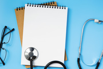 Stethoscope on a blue table, concept of medicine