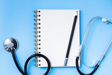 Stethoscope on a blue table, concept of medicine