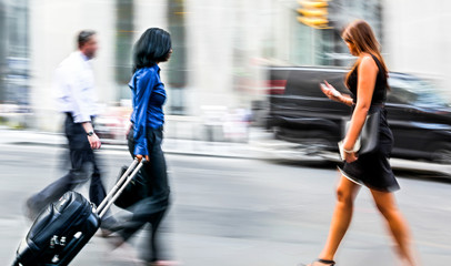 motion blurred business people walking on the street