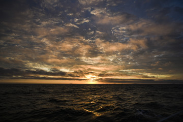 Beautiful colorful sunset with clouds on the north sea, summer