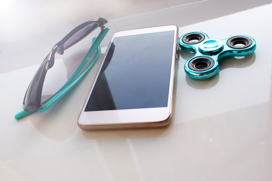 Spinner, sunglasses for the phone, spend the summer holidays. Modern toy for hands