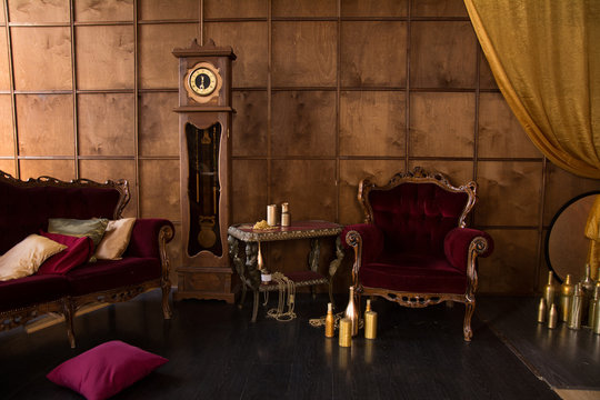 Interior with antique red furniture and clock.