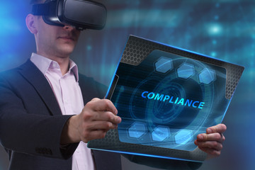 Business, Technology, Internet and network concept. Young businessman working on a virtual screen of the future and sees the inscription: Compliance