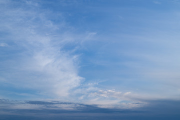Naklejka na ściany i meble White striped clouds on the blue sky