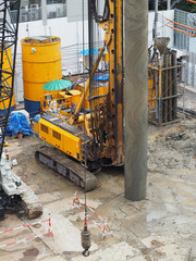 workers in construction area with crane truck and holding machine