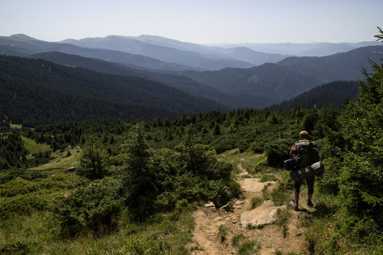 A man is traveling in the mountains
