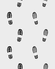 Prints of shoes on the gray background, seamless vector wallpaper