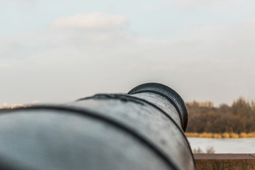 vintage cast iron gun on the bank of the river