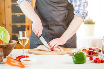 male preparing chicken for cooking