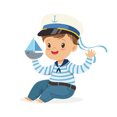 Cute smiling little boy character wearing a sailors costume sitting on the floor playing toy boat colorful vector Illustration