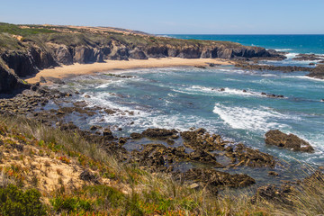 Fototapeta na wymiar Beach with cliffs and vegetation in Almograve