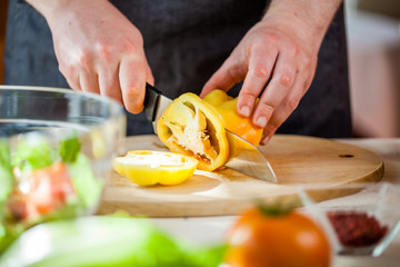 Chef cutting fresh and delicious vegetables for salad