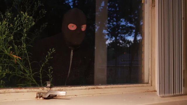 Burglar using crowbar to break into a house at night &ndash; 4K