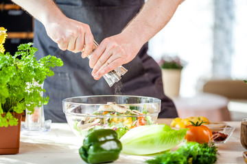 Chef cutting fresh and delicious vegetables for salad