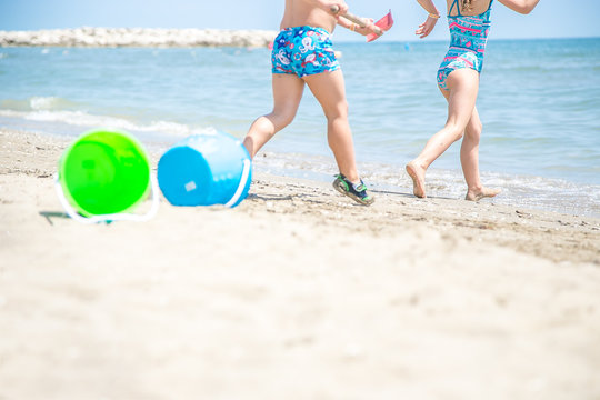 kids playing with beach toys on the beach in summer