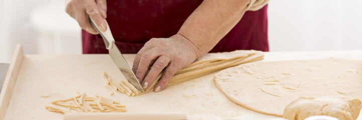Grandmother making pasta