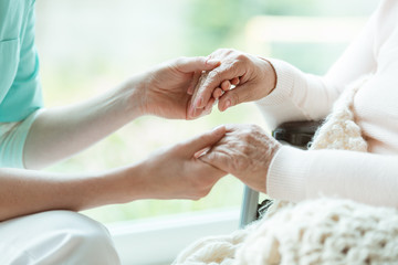 Nurse holding patient's hands