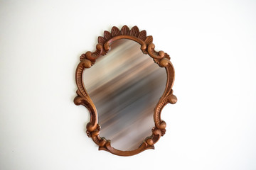 Wooden vintage mirror with blurry reflection