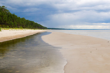 Baltic Sea Beach on Summer Day with Rain Clouds Panorama. Latvia, Gulf of Riga.