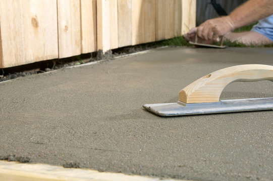 Close up of concreting tools and wet cement slab