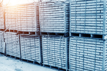 Cement building blocks stacked on pallets used for transportation and distribution at a hardware depot, warehouse or on a construction site