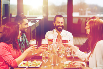 friends dining and drinking beer at restaurant