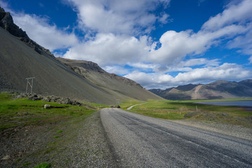 Iceland - Endless twisting road between ocean and volcanic mountains