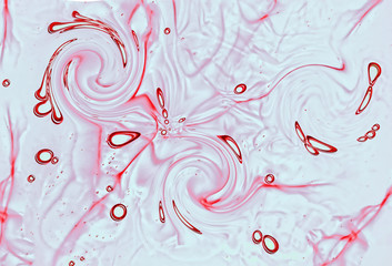 Fluid liquid macro with red swirls