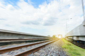 side view of railway track and crushes rock near the bridge with blue sky and cloudy background. milestone concept