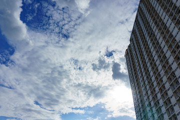 blue sky with cloud with building and sun