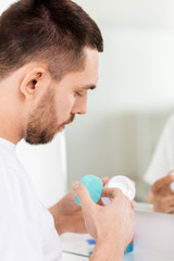 Fototapeta premium close up of young man with cream at bathroom