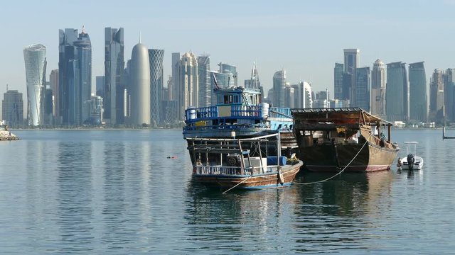 Traditional Dhow, Arab sailing vessels in the morning with the Doha skyline in the background in Qatar