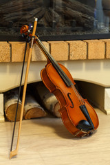 old violin by the fireplace