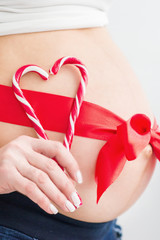 Pregnant belly with red heart