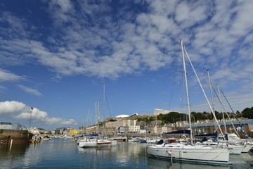 Fototapeta na wymiar Old St Helier Marina, Jersey, U.K. Wide angle image of a harbour at high tide in the Summer.