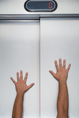 Man hands on elevator door