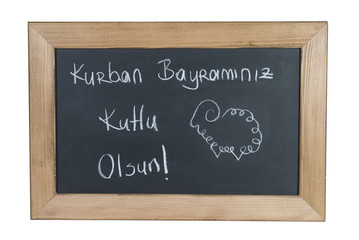 Sheep Drawing on Black Board for Feast of Sacrifice and written "Kurban Bayramınız Kutlu Olsun" on it