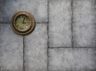 Antique wall clock on a cement wall
