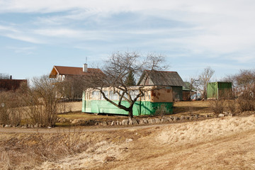 Fototapeta premium Small countryside view with old bus in the middle in garden.