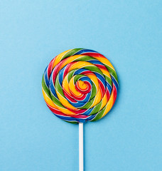 Tasty appetizing Party Accessory Sweet Swirl Candy Lollypop on Blue Background Top View