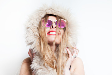 happy young woman wearing artificial fur and glasses 